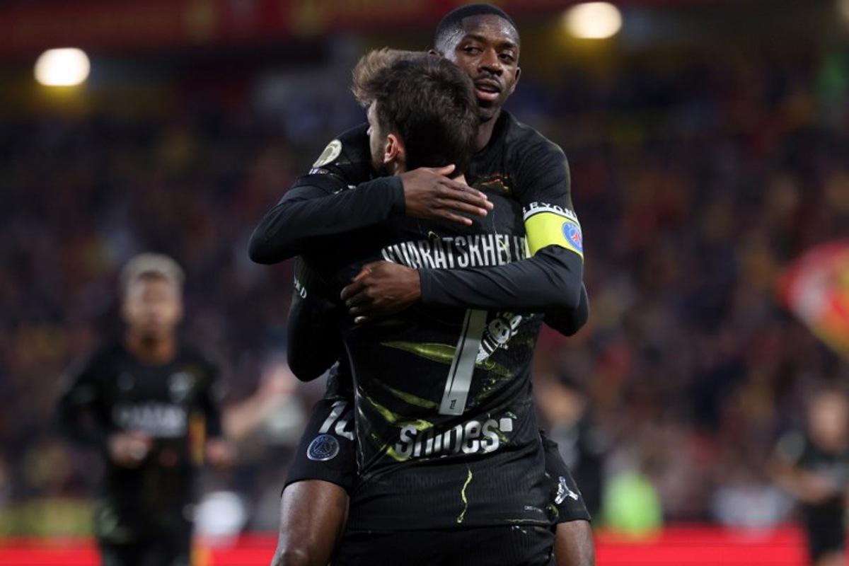Paris Saint-Germain's Georgian forward #07 Khvicha Kvaratskhelia (front) is congratulated by Paris Saint-Germain's French forward #10 Ousmane Dembele after scoring a goal during the French L1 football match between RC Lens and Paris Saint-Germain (PSG) at the Stade Bollaert-Delelis stadium in Lens on May 13, 2026.  Francois LO PRESTI / AFP