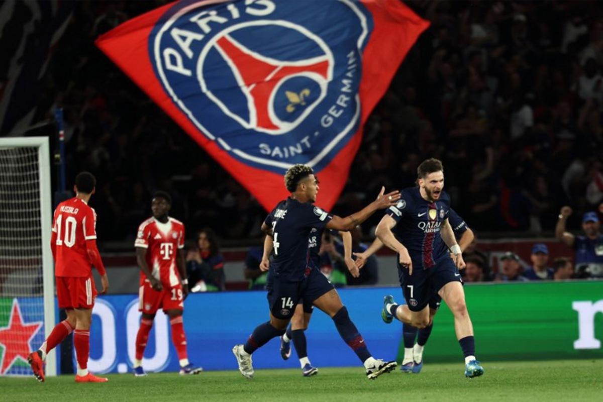 Paris Saint-Germain's Georgian forward #07 Khvicha Kvaratskhelia (R) celebrates with Paris Saint-Germain's French midfielder #14 Desire Doue after scoring his team first goal during the UEFA Champions League semi-final first leg football match between Paris Saint-Germain (PSG) and Bayern Munich at the Parc des Princes in Paris on April 28, 2026.  Anne-Christine POUJOULAT / AFP