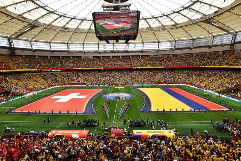 The flags of Switzerland and Colombia are displayed on the pitch ahead of their 2026 World Cup round of 16 football match at Vancouver Stadium in Vancouver on July 7, 2026.   Don MacKinnon / AFP