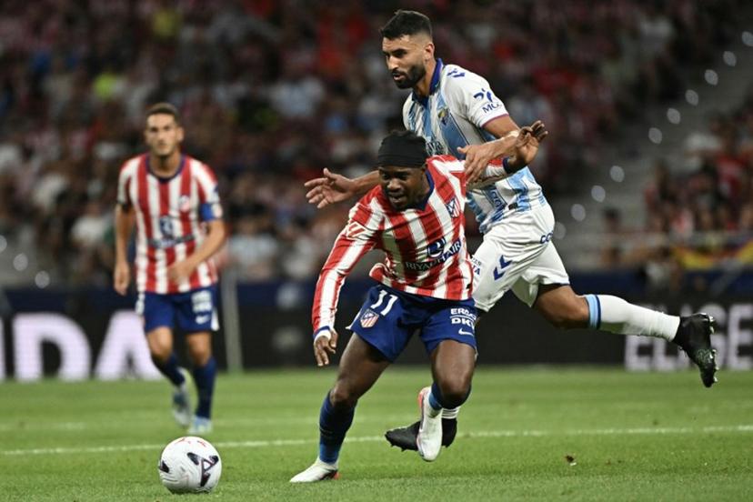 Atletico Madrid's Nigerian forward #11 Ademola Lookman vies with Malaga's Spanish defender #04 Einar Galilea (R) during the Spanish league football match between Club Atletico de Madrid and Malaga CF at the Metropolitano Stadium in Madrid on August 19, 2026.  Javier SORIANO / AFP