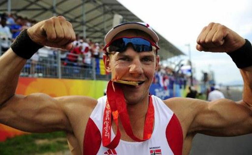 Norway's Olaf Tufte strikes a pose with his gold meda following the medals during the medal ceremony for the men's pair final  at the Shunyi Rowing and Canoeing Park during the 2008 Beijing Olympic Games in Beijing on August 16, 2008.  Norway won gold, Czech Republic Silver and New Zealand bronze.         AFP PHOTO / FRED DUFOUR