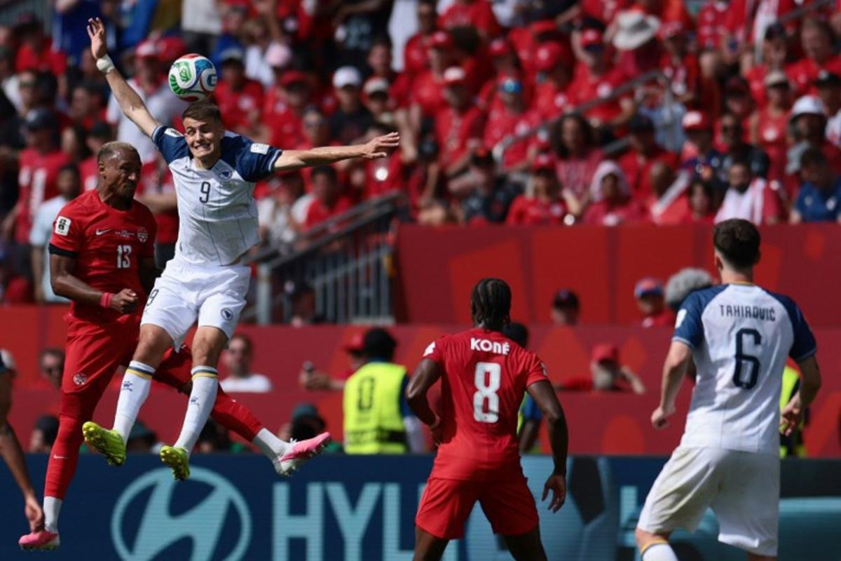 Canada's defender #13 Derek Cornelius (L) fights for the ball with Bosnia-Herzegovina's forward #09 Samed Bazdar (2ndL) during the 2026 World Cup Group B football match between Canada and Bosnia and Herzegovina at the Toronto Stadium in Toronto on June 12, 2026.  Cole Burston / AFP