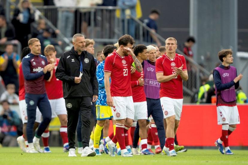 Denmark's midfielder #23 Pierre-Emile Hojbjerg (C), Denmark's defender Rasmus Nissen Kristensen (R) react after Christian Eriksen was taken away in an ambulance following his collapse during the football international friendly match between Denmark and Ukraine at Odense Stadium in Denmark, on June 7, 2026. Christian Eriksen collapsed during Denmark's friendly against Ukraine on June 7, 2026, five years after he suffered a cardiac arrest during the European Championships. Bo Amstrup / AFP