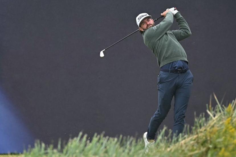 US golfer Cameron Young watches his iron shot from the 1st tee on the opening day of the 152nd British Open Golf Championship at Royal Troon on the south west coast of Scotland on July 18, 2024.  Paul ELLIS / AFP