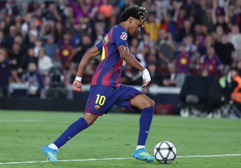 Barcelona's Spanish forward #10 Lamine Yamal scores his team's third goal during the Spanish league football match between FC Barcelona and RCD Espanyol at the Camp Nou stadium in Barcelona on April 11 , 2026.  Josep LAGO / AFP
