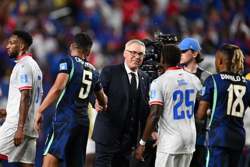 Brazil's Italian head coach Carlo Ancelotti shakes hands with midfielder #05 Casemiro past Haiti's midfielder #25 Dominique Simon after the 2026 World Cup Group C football match between Brazil and Haiti at the Philadelphia Stadium in Philadelphia on June 19, 2026. ROBERTO SCHMIDT / AFP