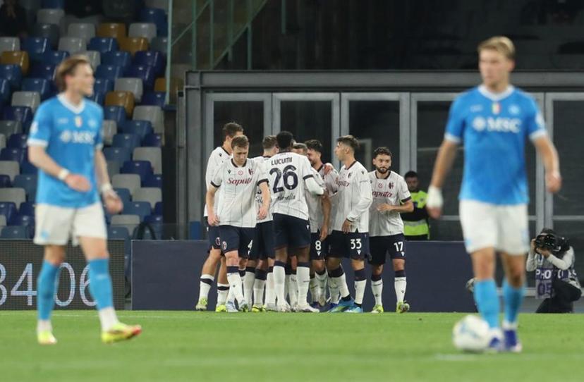 Bologna's Italian forward #7 Riccardo Orsolini (hidden) celebrates with teammates after scoring a goal on penalty during the Italian Serie A football match between SSC Napoli and Bologna FC 1909 at the Diego Armando Maradona Stadium in Naples on May 11, 2026.  CARLO HERMANN / AFP