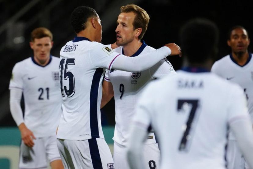 England's forward #09 Harry Kane celebrates scoring the 0-2 goal with his teammates including England forward #15 Morgan Rogers during the 2026 World Cup qualifying group K football match between Latvia and England at the Daugava Stadium in Riga, Latvia on October 14, 2025,    Gints Ivuskans / AFP