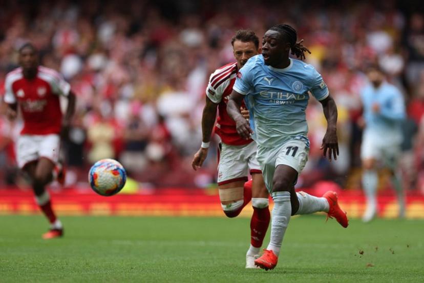 Manchester City's Belgian midfielder #11 Jeremy Doku runs with the ball during the English FA Community Shield football match between Arsenal and Manchester City at The Principality Stadium, in Cardiff, south Wales on August 16, 2026.  Adrian Dennis / AFP
