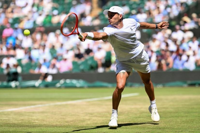 Italy's Flavio Cobolli returns to Australia's Alex De Minaur during their men's singles round of 16 tennis match on the eighth day of the 2026 Wimbledon Championships at The All England Lawn Tennis and Croquet Club in Wimbledon, southwest London, on July 6, 2026.  Kirill KUDRYAVTSEV / AFP