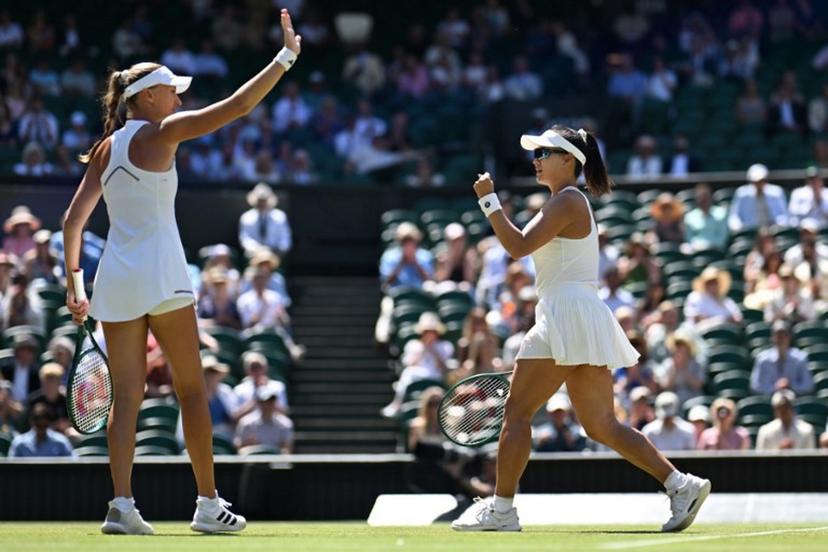 China's Guo Hanyu (R) and France's Kristina Mladenovic celebrate winning a point against Brazil's Luisa Stefani and Canada's Gabriela Dabrowski during their women's doubles final tennis match on the fourteenth day of the 2026 Wimbledon Championships at The All England Lawn Tennis and Croquet Club in Wimbledon, southwest London, on July 12, 2026.  Kirill KUDRYAVTSEV / AFP