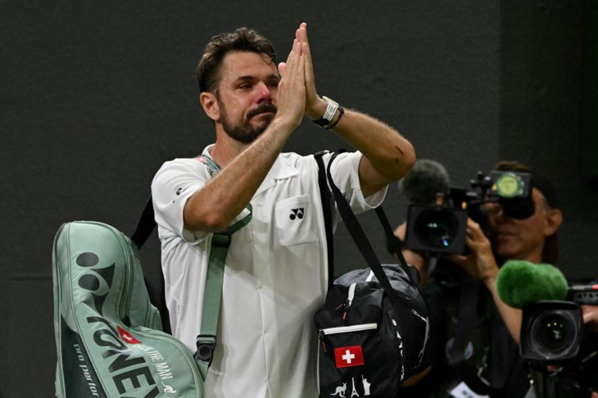 Switzerland's Stan Wawrinka gestures to the crowd as he leaves following his defeat to Italy's Matteo Berrettini during their men's singles first round tennis match on the second day of the 2026 Wimbledon Championships at The All England Lawn Tennis and Croquet Club in Wimbledon, southwest London, on June 30, 2026.  Glyn KIRK / AFP
