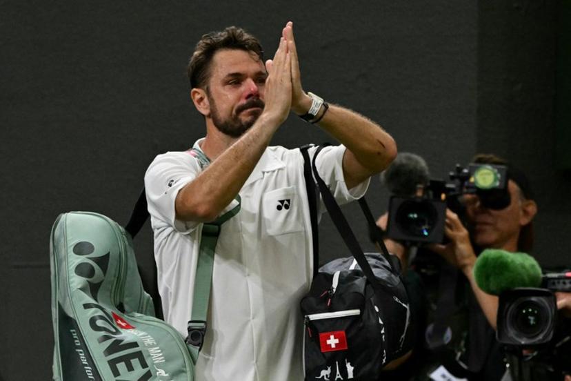 Switzerland's Stan Wawrinka gestures to the crowd as he leaves following his defeat to Italy's Matteo Berrettini during their men's singles first round tennis match on the second day of the 2026 Wimbledon Championships at The All England Lawn Tennis and Croquet Club in Wimbledon, southwest London, on June 30, 2026.  Glyn KIRK / AFP