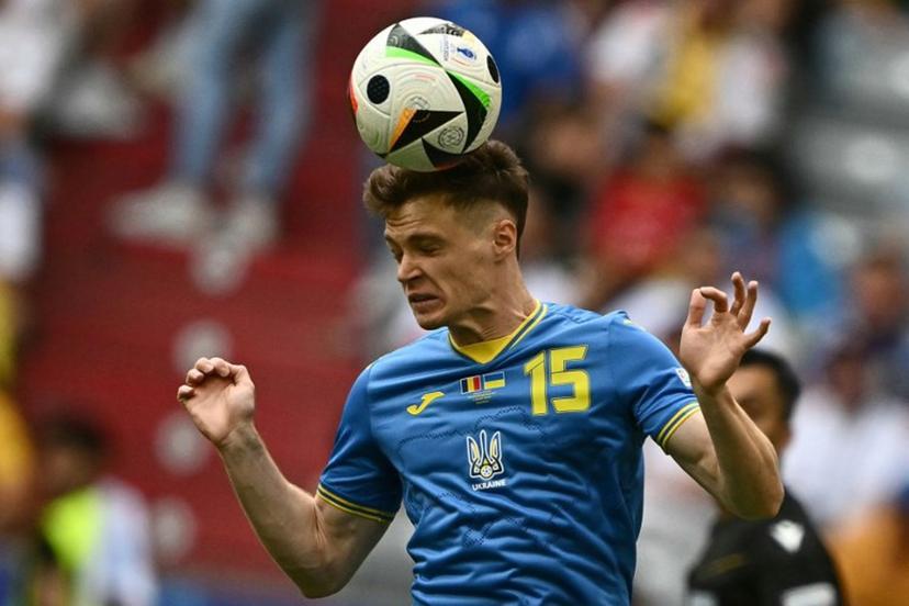 Ukraine's midfielder #15 Viktor Tsygankov heads the ball during the UEFA Euro 2024 Group E football match between Romania and Ukraine at the Munich Football Arena in Munich on June 17, 2024.  Fabrice COFFRINI / AFP