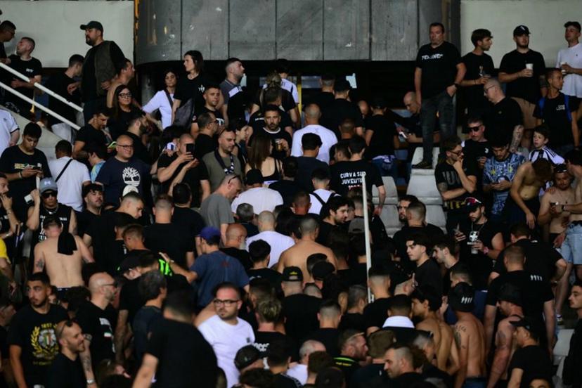 Juventus' supporters leave the stadium after a suspension of the Italian Serie A football match betweem Torino and Juventus FC at the Olympic Stadium Grande Torino in Turin on May 24, 2026.  MARCO BERTORELLO / AFP