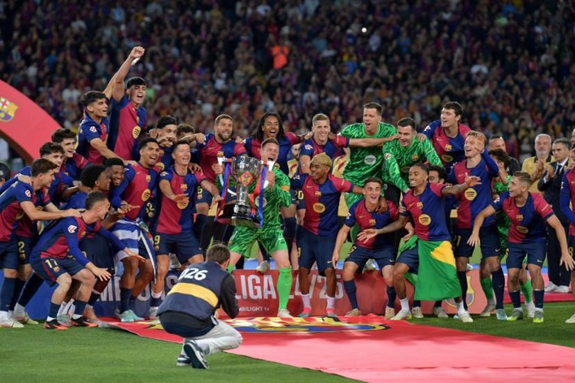 Barcelona's players celebrate their 28th Liga title after the Spanish league football match between FC Barcelona and Villarreal CF at Estadi Olimpic Lluis Companys in Barcelona on May 18, 2025.  MANAURE QUINTERO / AFP