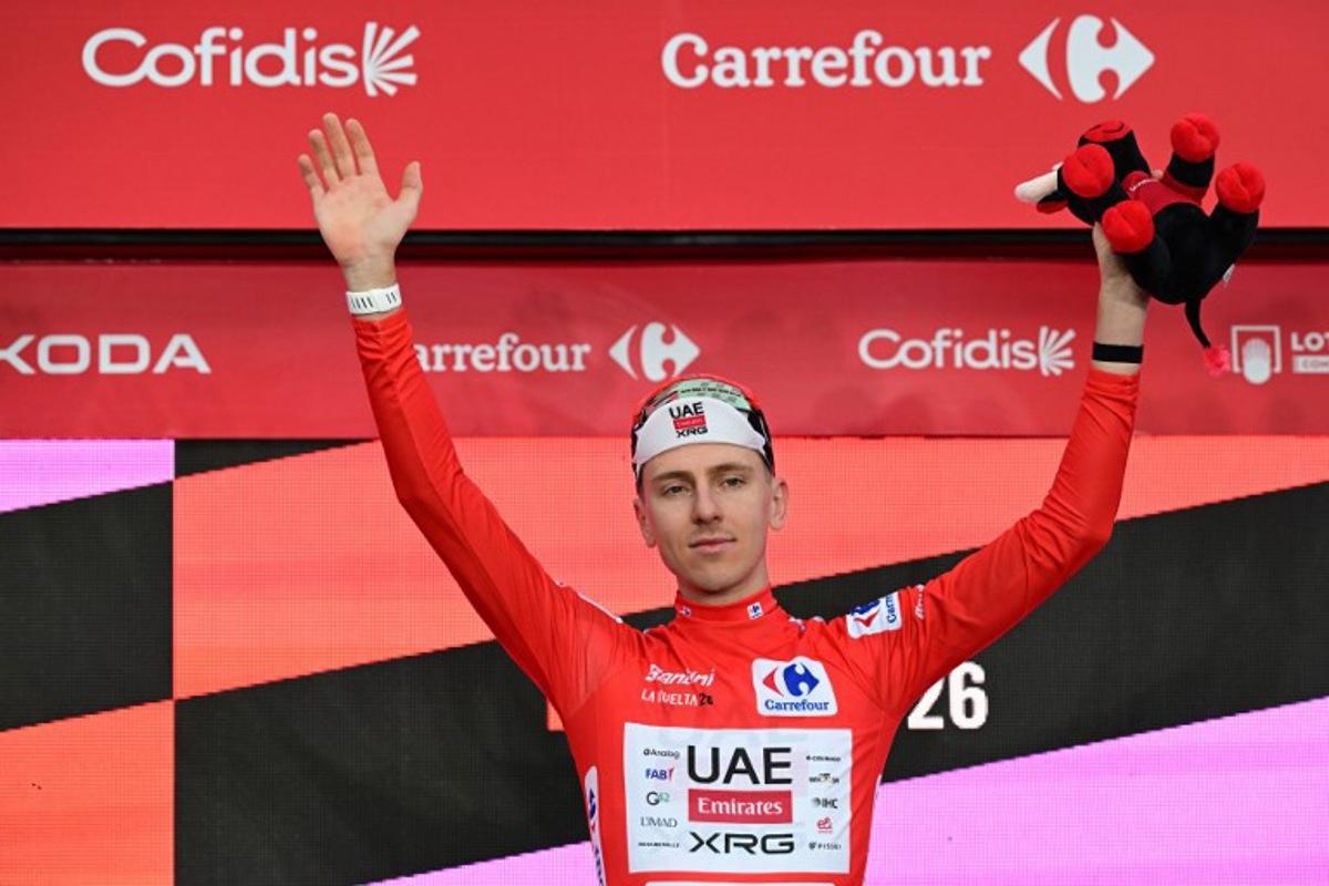UAE Team Emirates - XRG team's Slovenian rider Tadej Pogacar celebrates on the podium wearing the overall leader's red jersey, after winning the first stage of the Vuelta a Espana 2026, a 9,4 km time-trial between Monaco and Monaco on August 22, 2026.  Miguel MEDINA / AFP