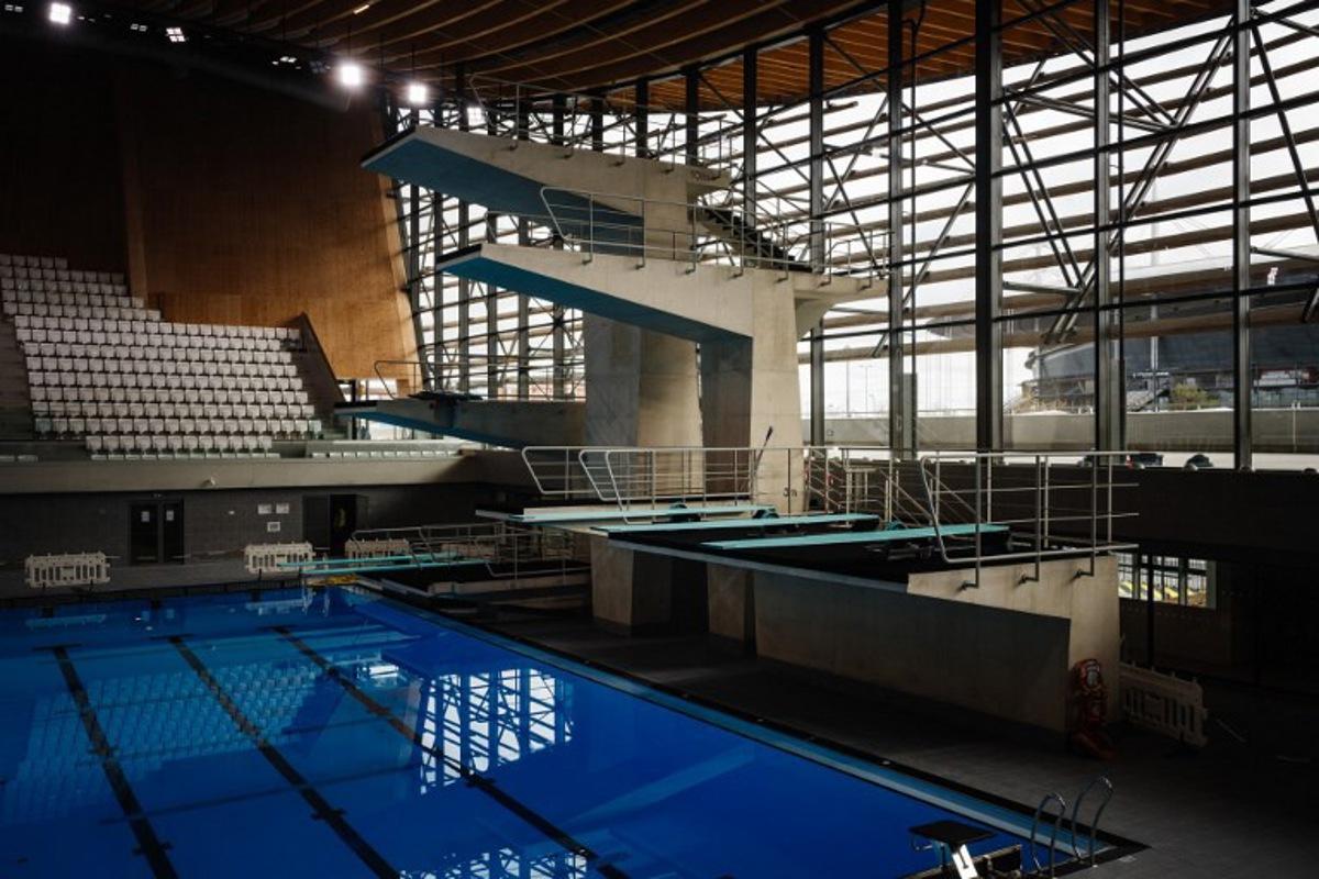 This photograph taken on March 28, 2024 shows diving boards, next to a swimming pool, in the Aquatics Centre built for the Paris 2024 Olympic Games to be used for artistic swimming, diving and water polo competitions in Saint Denis, near Paris.  Dimitar DILKOFF / AFP