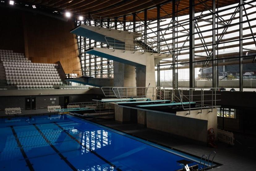 This photograph taken on March 28, 2024 shows diving boards, next to a swimming pool, in the Aquatics Centre built for the Paris 2024 Olympic Games to be used for artistic swimming, diving and water polo competitions in Saint Denis, near Paris.  Dimitar DILKOFF / AFP