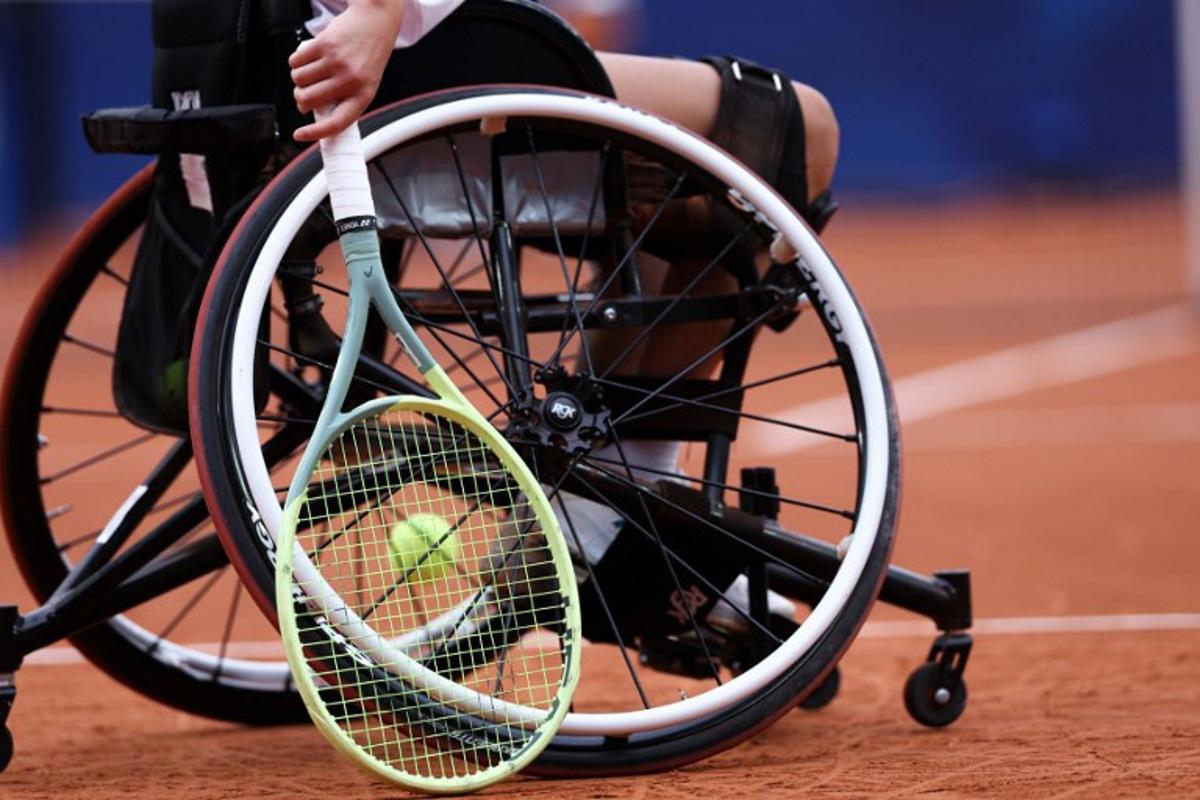 China's Luoyao Guo holds her racket as she competes during the quarter-finals of the women's wheelchair tennis match against Netherlands' Diede De Groot on the Suzanne-Lenglen Court at the Roland-Garros Stadium, during the Paris 2024 Paralympic Games on September 3, 2024.  ALAIN JOCARD / AFP