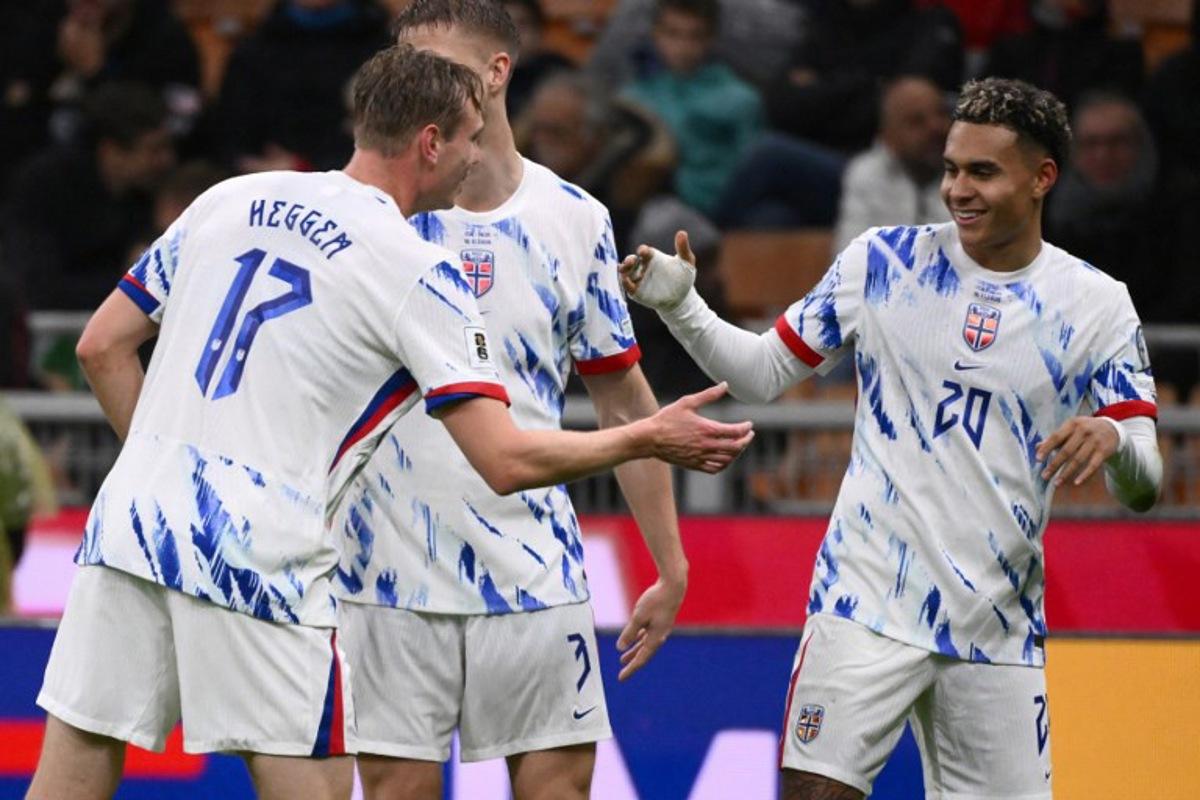 Norway's forward #20 Antonio Nusa celebrates with teammate Norway's  defender #17 Torbjorn Lysaker Heggem after scoring his team's first goal during the FIFA World Cup 2026 European qualification football match between Italy and Norway, at the San Siro Stadium, in Milan, on November 16, 2025.     Alberto PIZZOLI / AFP