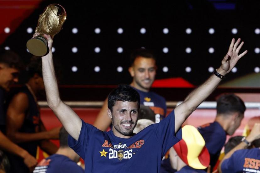 Spain's captain Rodri raises the World Cup trophy as he celebrates with teammates on a stage at Cibeles Square in Madrid on July 20, 2026, one day after winning their second World Cup title following a 1-0 victory against Argentina. Spain's World Cup winners come back home to a heroes' welcome in Madrid, where a million fans are expected to greet them after a night of raucous celebrations across the country. Oscar DEL POZO / AFP
