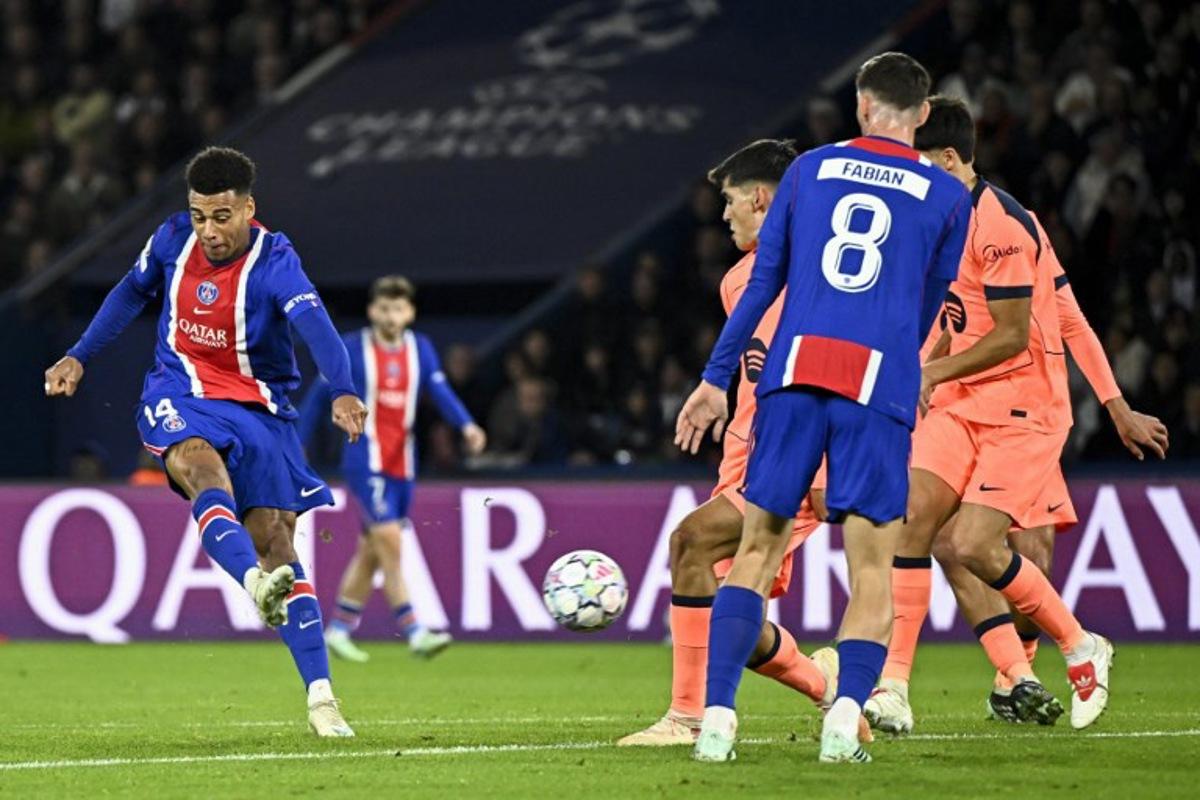 PSG's French forward #14 Desire Doue (L) shoots to score his team's first goal during the UEFA Champions League first round day 3 football match between Paris Saint-Germain (PSG) and FC Barcelona at the Parc de Princes stadium in Paris on October 20, 2026.  JULIEN DE ROSA / AFP