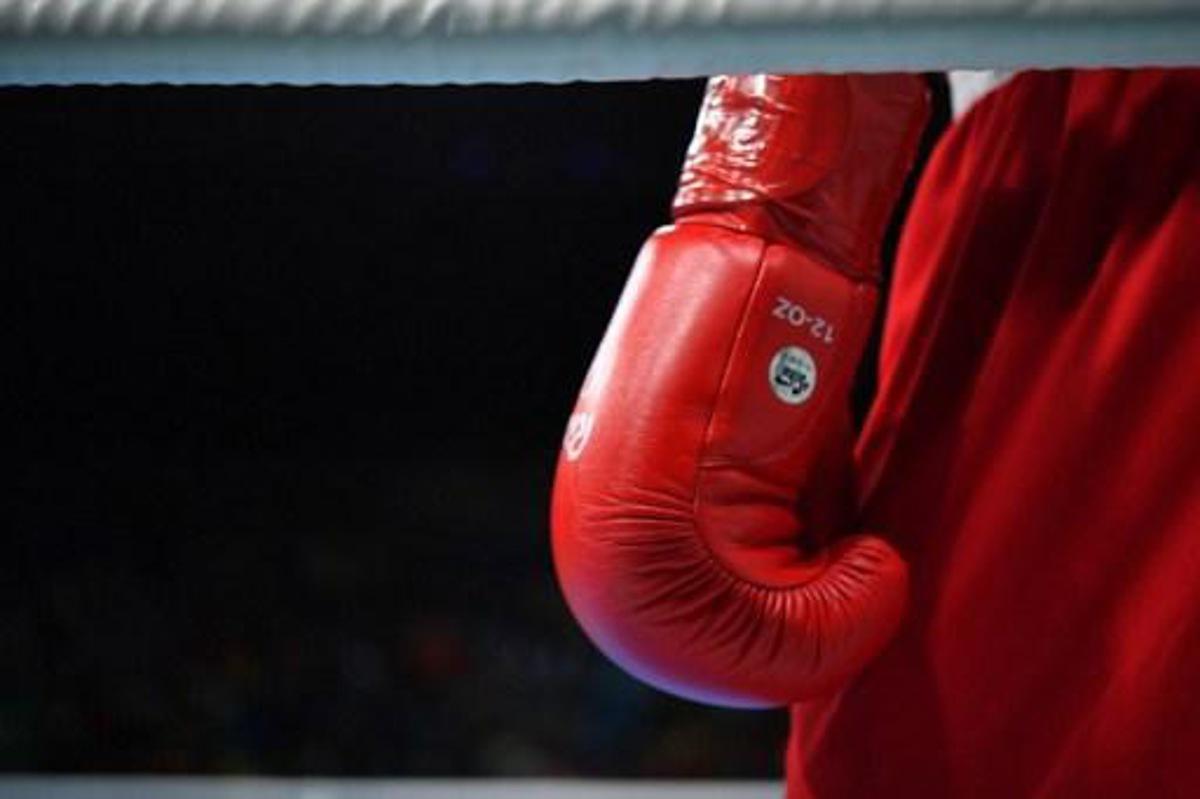 A close up shot shows Morocco's Mohammed Rabii's boxing glove as he fights Kenya's Rayton Nduku Okwiri during the Men's Welter (69kg) match at the Rio 2016 Olympic Games at the Riocentro - Pavilion 6 in Rio de Janeiro on August 11, 2016.   
Yuri CORTEZ / AFP