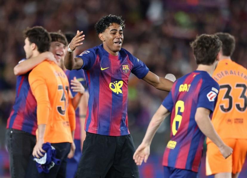Barcelona's Spanish forward #10 Lamine Yamal celebrates with teammates winning the Spanish league football match between FC Barcelona and Real Madrid CF at Camp Nou Stadium in Barcelona on May 10, 2026. Barcelona won 2-0. Josep LAGO / AFP