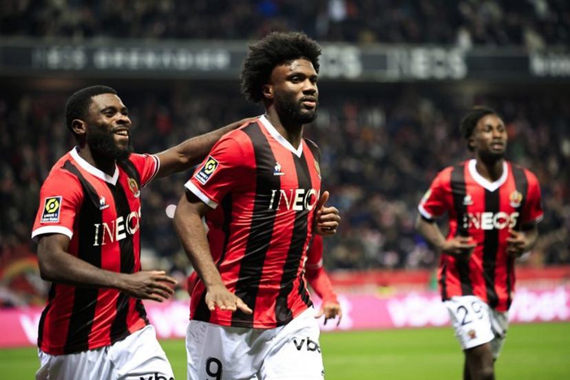 Nice's Nigerian forward #09 Terem Moffi (C) celebrates with Nice's Ivorian forward #07 Jeremie Boga (L) after scoring his side's second goal during the French L1 football match between OGC Nice and RC Lens at the Allianz Riviera Stadium in Nice, south-eastern France, on December 20, 2023.   Valery HACHE / AFP