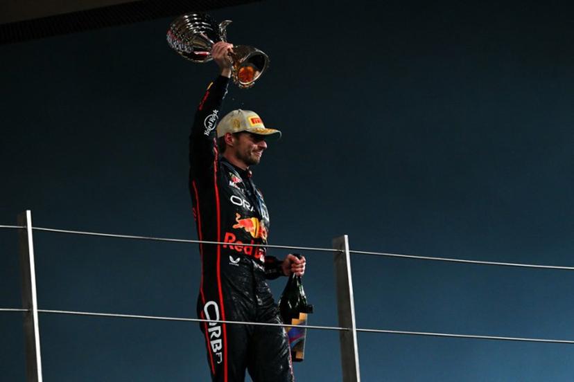 Race winner Red Bull Racing's Dutch driver Max Verstappen celebrates on the podium at the end of the Abu Dhabi Formula One Grand Prix at the Yas Marina Circuit in Abu Dhabi on December 7, 2025.  Andrej ISAKOVIC / AFP