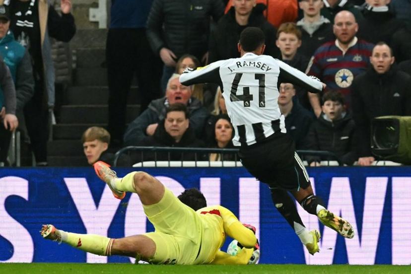 Newcastle United's English midfielder #41 Jacob Ramsey goes down after Manchester United's Belgian goalkeeper #31 Senne Lammens takes the ball from him, he was subsequently sent off for a second yellow card for simulation during the English Premier League football match between Newcastle United and Manchester United at St James' Park in Newcastle-upon-Tyne, north east England on March 4, 2026.  ANDY BUCHANAN / AFP
