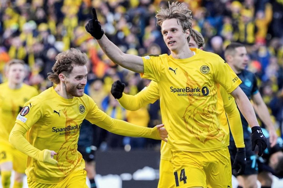 Bodoe/Glimt's Norwegian midfielder #14 Ulrik Saltnes (R) celebrates his 1-0 during the UEFA Europa League Quarter Final, 1st leg football match Bodo/Glimt v S S Lazio in Bodo, Norway, on April 10, 2025. Lise Åserud / NTB / AFP