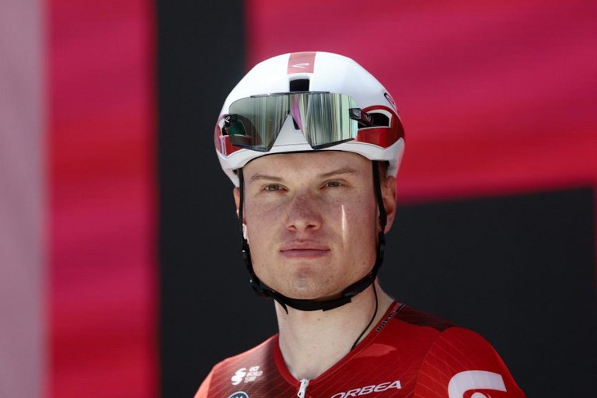 Lotto Intermarche Belgian rider Lennert Van Eetvelt stands on the signature podium before the 8th stage of the Giro d'Italia 2026 - Tour of Italy cycling race between Chieti and Fermo, central Italy on May 16, 2026. Luca Bettini / AFP