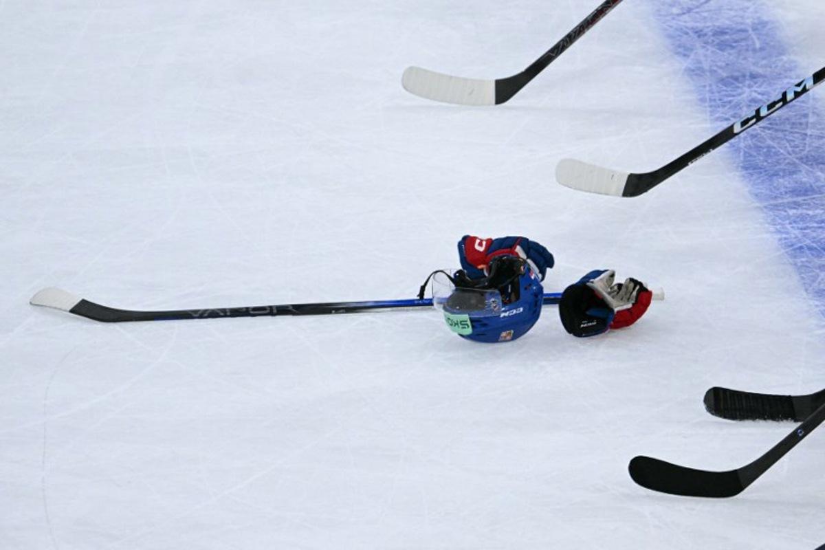 This photograph shows an Ice Hockey helmet, gloves and an Ice Hockey stick at the end of the IIHF Ice Hockey Men's World Championship quarter-final match between Finland and Czech Republic at the Swiss Life Arena in Zurich, Switzerland on May 28, 2026. SEBASTIEN BOZON / AFP