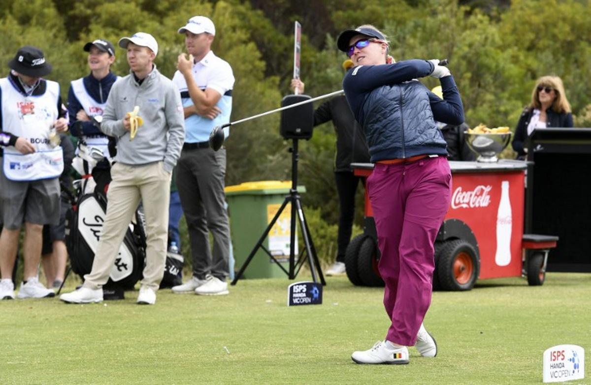 Female golfer Manon De Roey of Belgium (R) tees off as male players Gavin Moynihan of Ireland (3/L) and Dale Williamson of Australia (4/L) look on during the third round of the joint EPGA and LPGA Vic Open golf tournament at the 13th Beach Golf Links at Barwon Heads near Melbourne on February 9, 2019. WILLIAM WEST / AFP