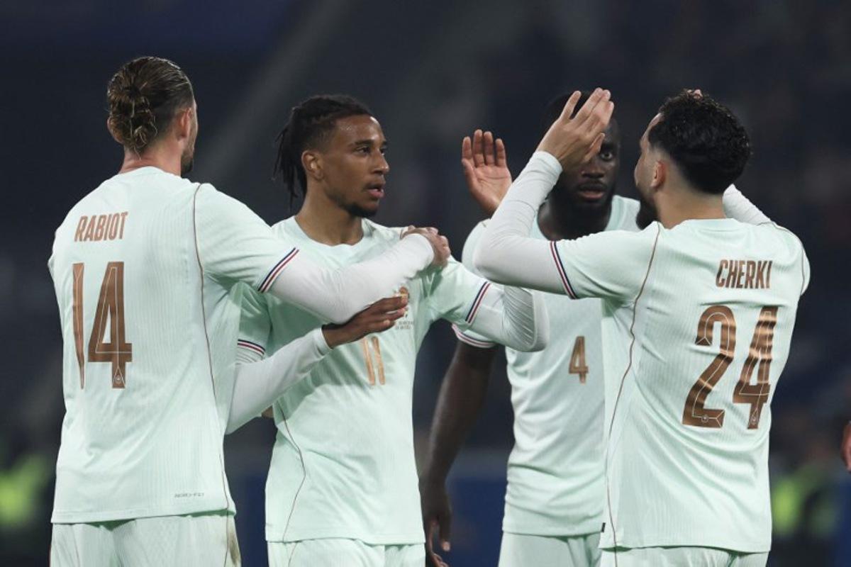 France's forward #11 Michael Olise (2L) celebrates scoring his team's third goal with France's midfielder #14 Adrien Rabiot (L) and France's defender #04 Dayot Upamecano and France's forward #24 Rayan Cherki (R) during the international friendly football match between France and North Ireland at the Decathlon Arena - Pierre Mauroy stadium in Villeneuve-d'Ascq, northern France on June 8, 2026, ahead of the 2026 FIFA World Cup football tournament. FRANCK FIFE / AFP