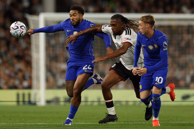 Chelsea's English defender #24 Reece James (L) vies with Fulham's Nigerian midfielder #17 Alex Iwobi (C) during the English Premier League football match between Fulham and Chelsea at Craven Cottage in London on August 24, 2026. Adrian Dennis / AFP