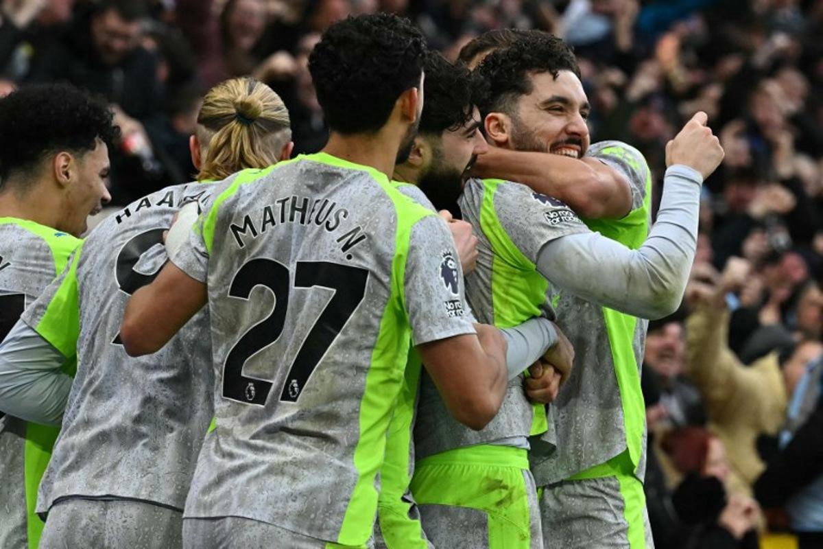 Manchester City's French midfielder #10 Rayan Cherki (R) celebrates with teammates after scoring their second goal during the English Premier League football match between Nottingham Forest and Manchester City at The City Ground in Nottingham, central England, on December 27, 2025. Ben STANSALL / AFP