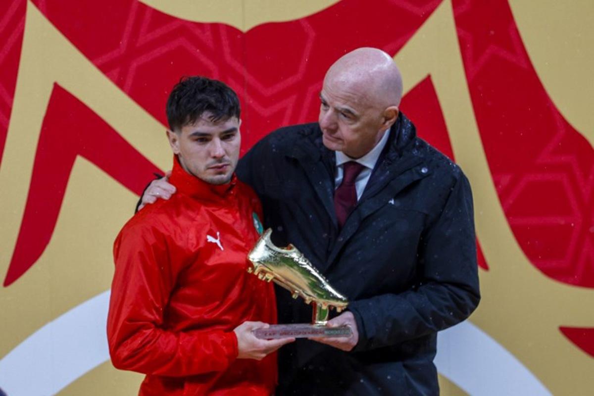 Morocco's forward #10 Brahim Diaz receives the Golden Boot from FIFA President Gianni Infantino during presentation ceremony at the end of the Africa Cup of Nations (CAN) final football match between Senegal and Morocco at the Prince Moulay Abdellah Stadium in Rabat on January 18, 2026. Abdel Majid BZIOUAT / AFP