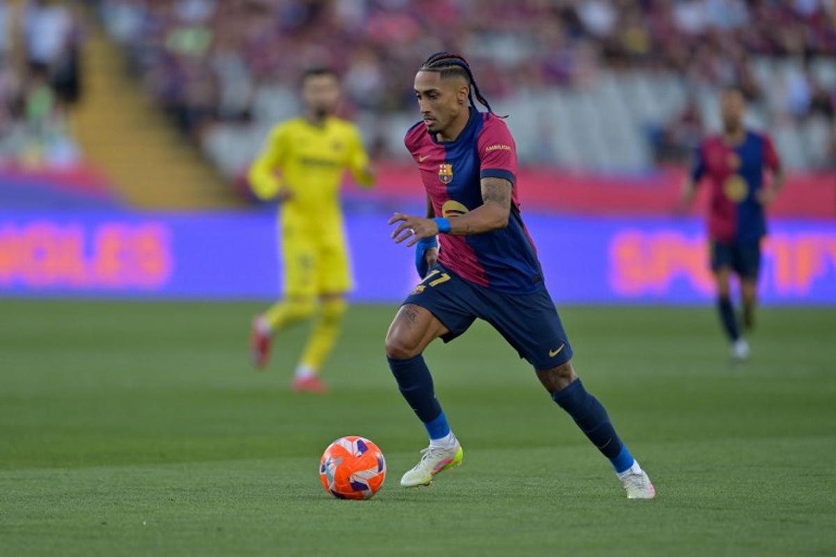 Barcelona's Brazilian forward #11 Raphinha controls the ball during the Spanish league football match between FC Barcelona and Villarreal CF at Estadi Olimpic Lluis Companys in Barcelona on May 18, 2025. MANAURE QUINTERO / AFP