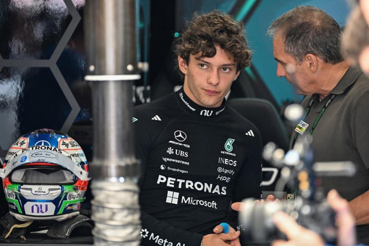 Mercedes' Italian driver Kimi Antonelli (L) speaks with his dad Marco Antonelli (R) before the qualifying session ahead of the Formula One British Grand Prix at the Silverstone motor racing circuit in Silverstone, central England, on July 4, 2026. PETER POWELL / POOL / AFP