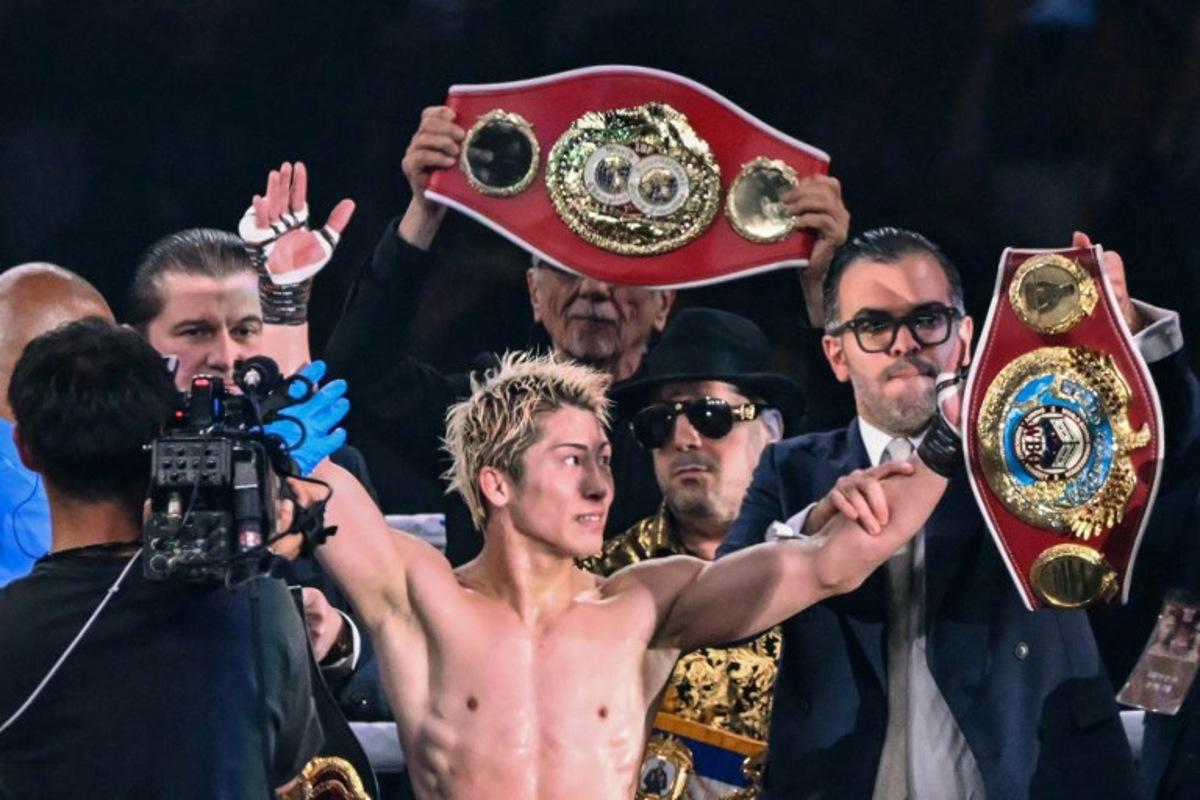Naoya Inoue (C) celebrates defeating Junto Nakatani in their super bantamweight championship boxing contest at Tokyo Dome in Tokyo on May 2, 2026. Yuichi YAMAZAKI / AFP