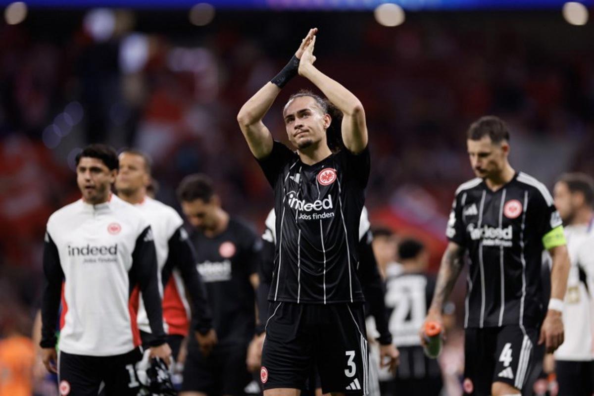 Eintracht Frankfurt's Belgian defender #03 Arthur Theate (C) acknowledges supporters after the UEFA Champions League, league Phase - matchday 2 football match between Club Atletico de Madrid and Eintracht Frankfurt at the Metropolitano stadium in Madrid on September 30, 2025. Oscar DEL POZO / AFP