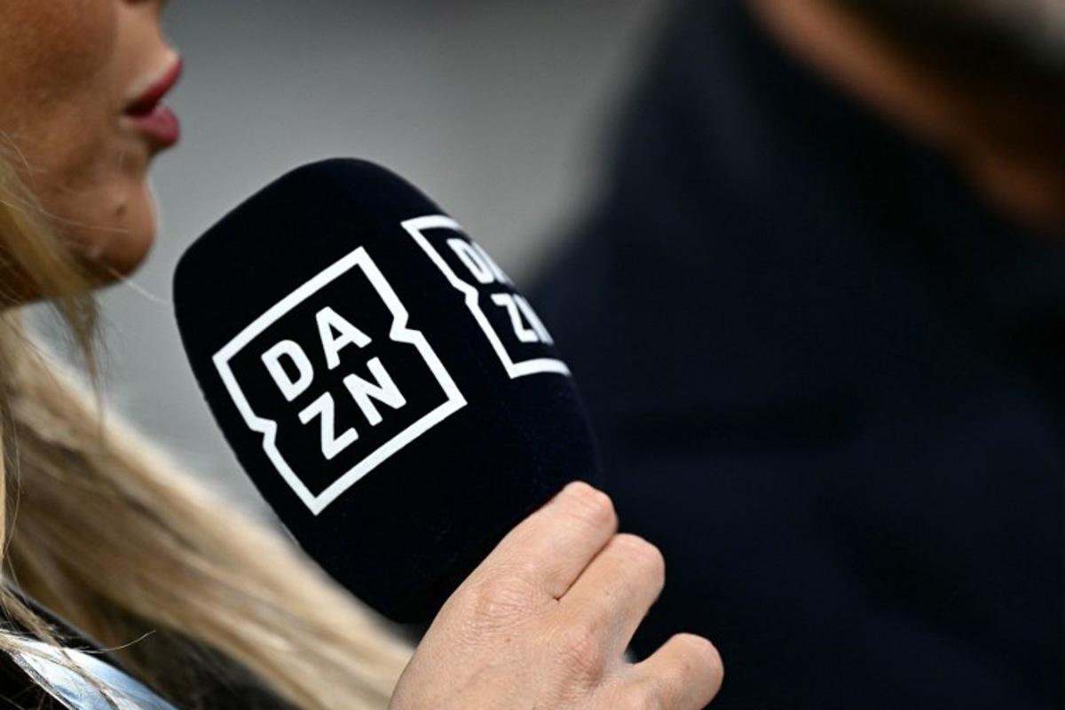 A presenter of sports streaming service DAZN holds a microphone during the Italian Serie A football match between Juventus and Cagliari, at The Allianz Stadium, in Turin on November 11, 2023. GABRIEL BOUYS / AFP