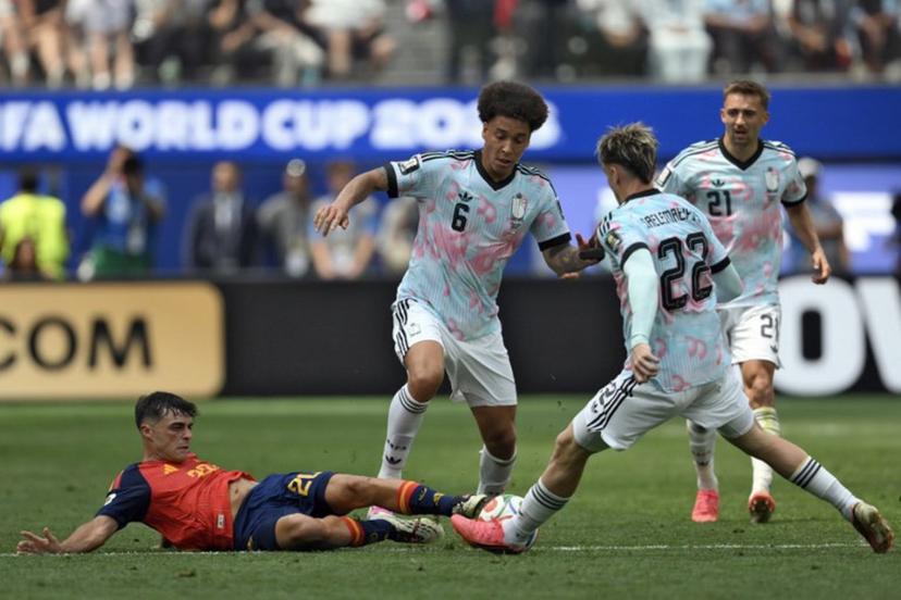 Spain's midfielder #20 Pedri, midfielder #06 Axel Witsel, and Belgium's forward #22 Alexis Saelemaekers fight for the ball during the 2026 World Cup football tournament quarter-final match between Spain and Belgium at the Los Angeles Stadium in Inglewood on July 10, 2026. Patrick T. Fallon / AFP
