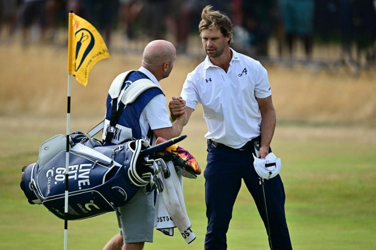 Belgium's Thomas Detry shakes hands with his caddie Lee Warne after his second round 69 on day two of the 154th Open Golf championship at Royal Birkdale Golf Club near Southport in north-west England on July 17, 2026. Ben STANSALL / AFP
