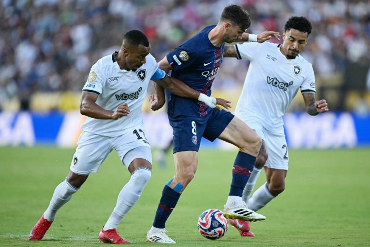 Paris Saint-Germain's Spanish midfielder #08 Fabian Ruiz, Botafogo's Brazilian midfielder #17 Marlon Freitas (L) and Brazilian midfielder #26 Gregore fight for the ball during the FIFA Club World Cup 2025 Group B football match between France's Paris Saint-Germain and Brazil's Botafogo at the Rose Bowl stadium in Los Angeles on June 19, 2025. YURI CORTEZ / AFP