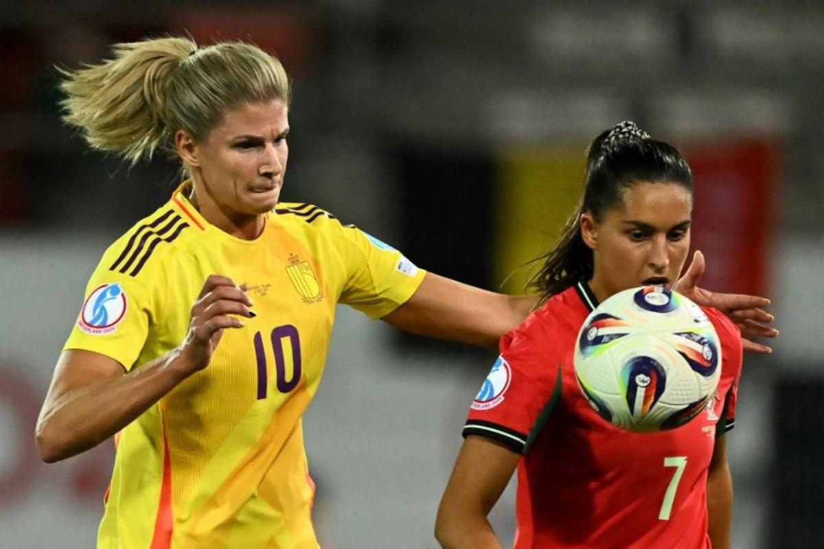 Belgium's midfielder #10 Justine Vanhaevermaet and Portugal's forward #07 Francisca Nazareth eye the ball during the UEFA Women's Euro 2025 Group B football match between Portugal and Belgium at the Stade de Tourbillon in Sion, on July 11, 2025. Fabrice COFFRINI / AFP