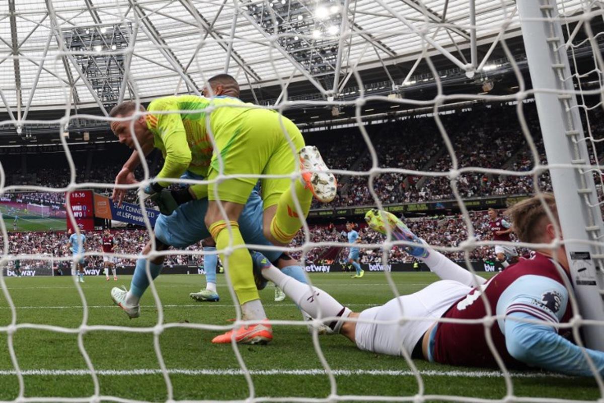 West Ham United's English striker #20 Jarrod Bowen colides with the post during the English Premier League football match between West Ham United and Nottingham Forest at the London Stadium, in London on May 18, 2025. HENRY NICHOLLS / AFP